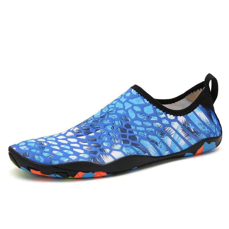 Blue and camouflage Lycra beach wading shoes with EVA midsoles on a sandy background