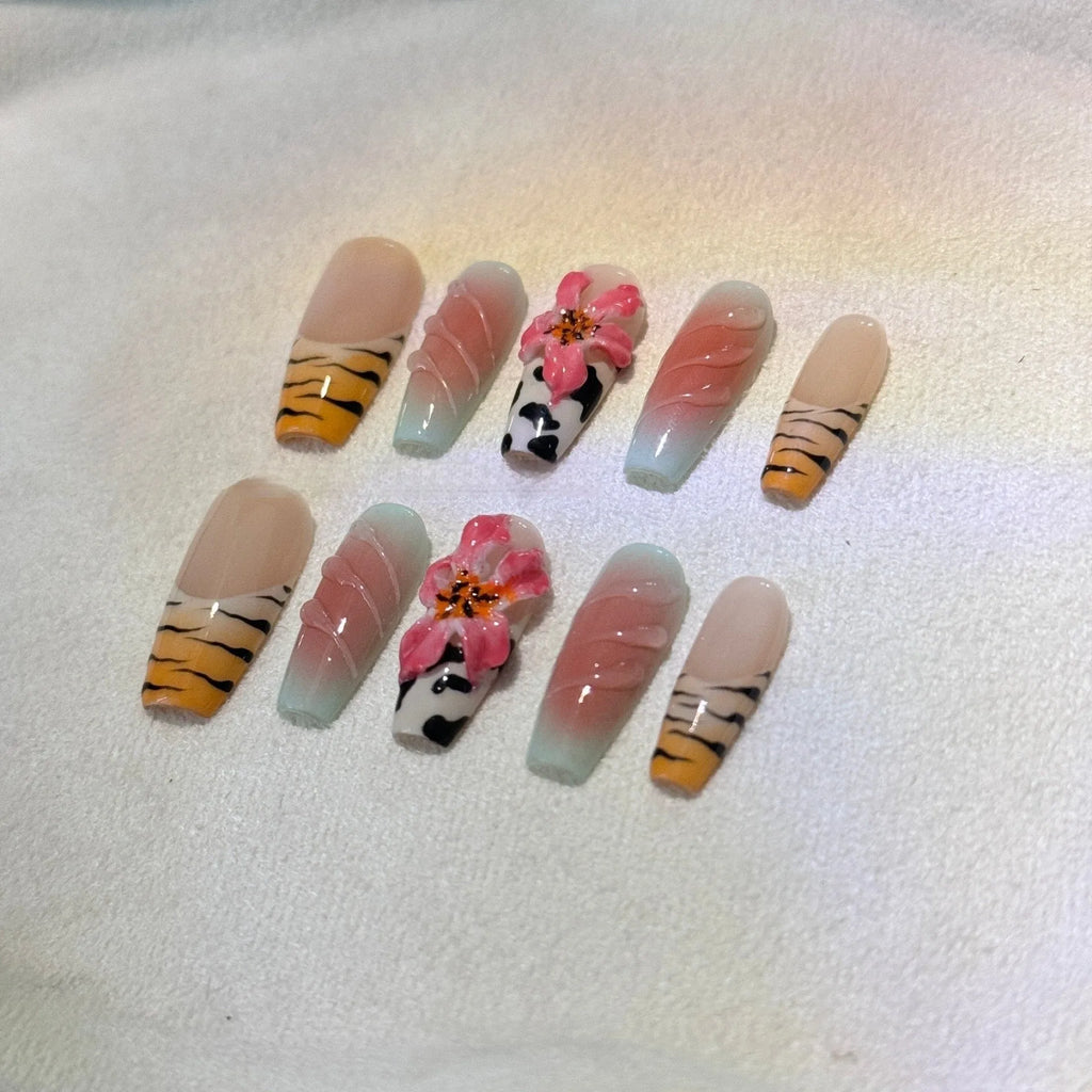 Set of zebra pattern lily hand-carved artificial nail tips with flower and leopard print designs in sizes XS to L