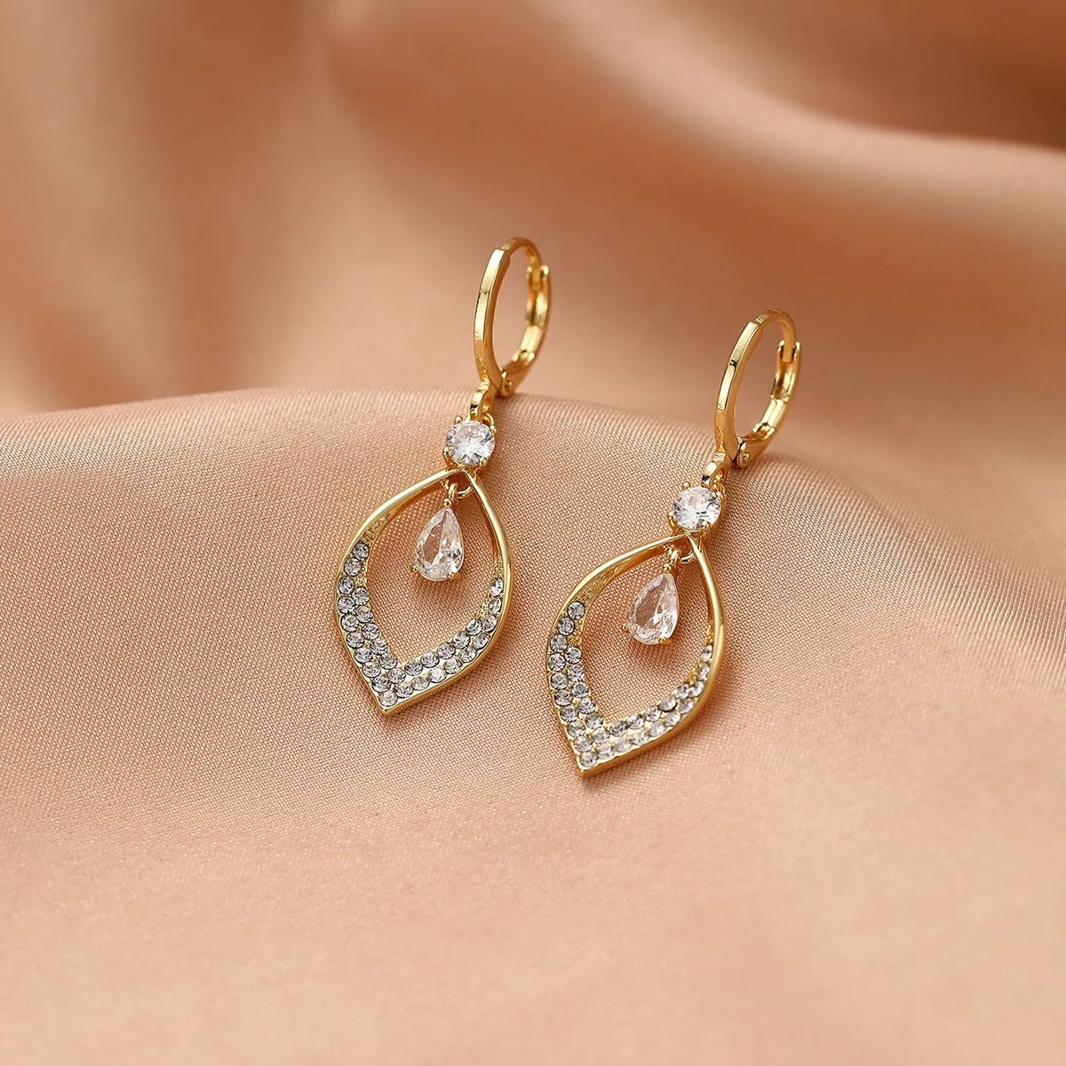 Women's gold and silver water drop tassel earrings made from zircon and copper.