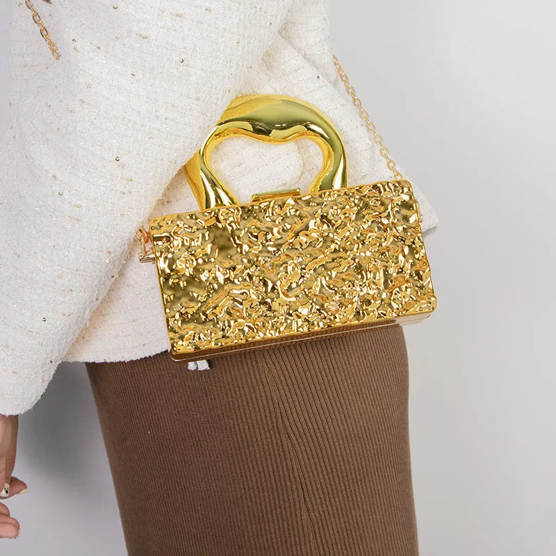 Mini crossbody bag with hard acrylic shell, chain strap, and phone pocket in Golden Ripples colour