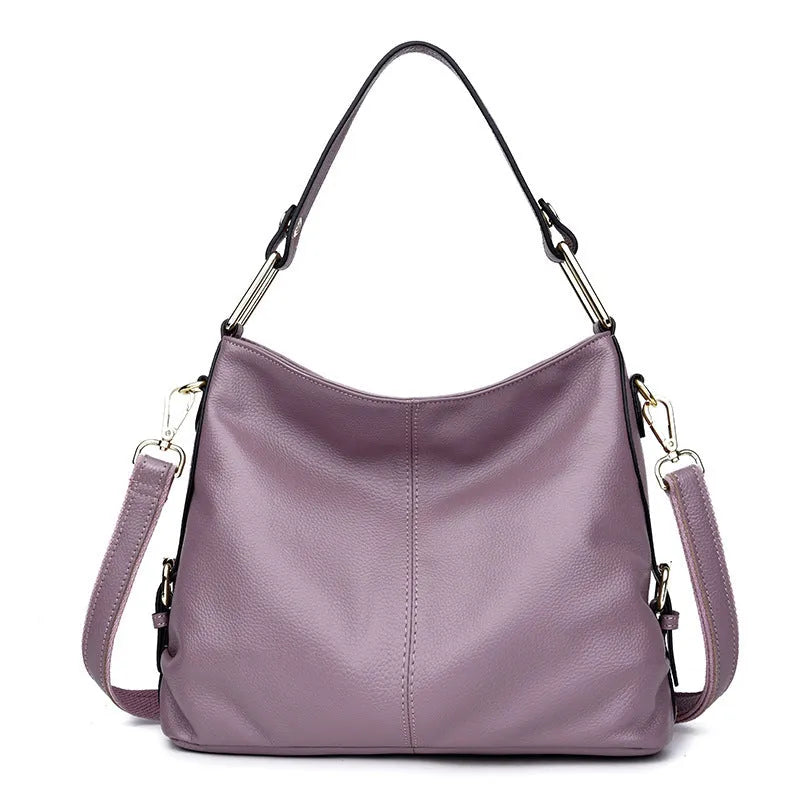 Genuine leather vertical square crossbody bag in black colour with visible stitching and multiple compartments.