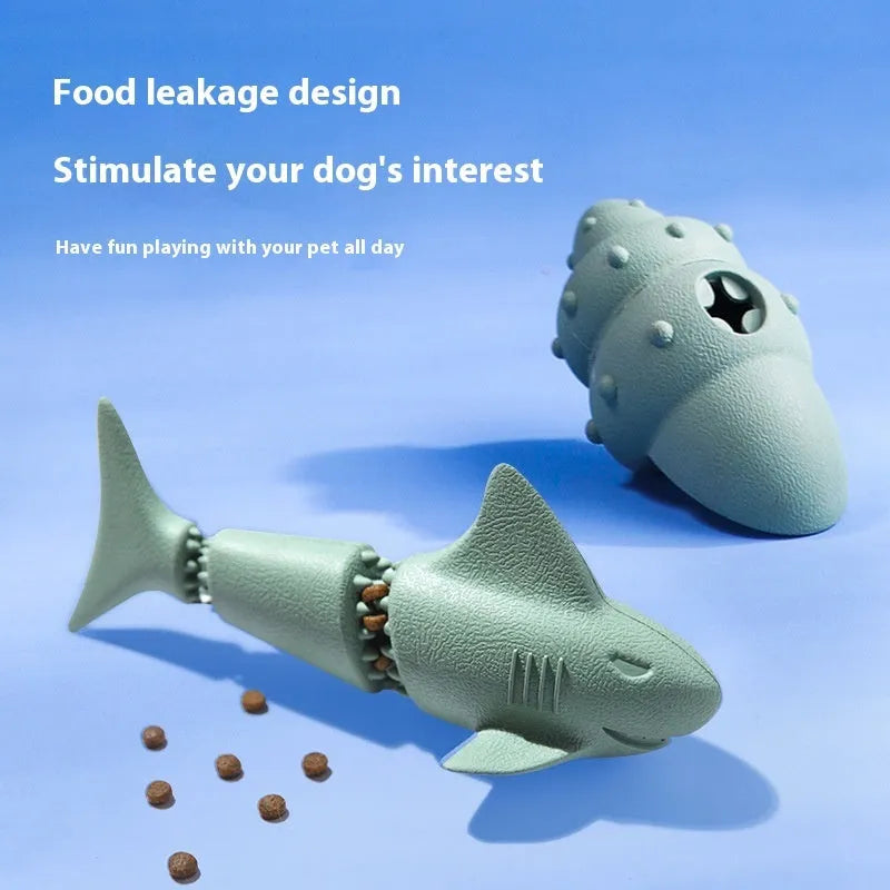 Blue rubber shark-shaped dog toy with a hidden food compartment for interactive chewing and feeding.