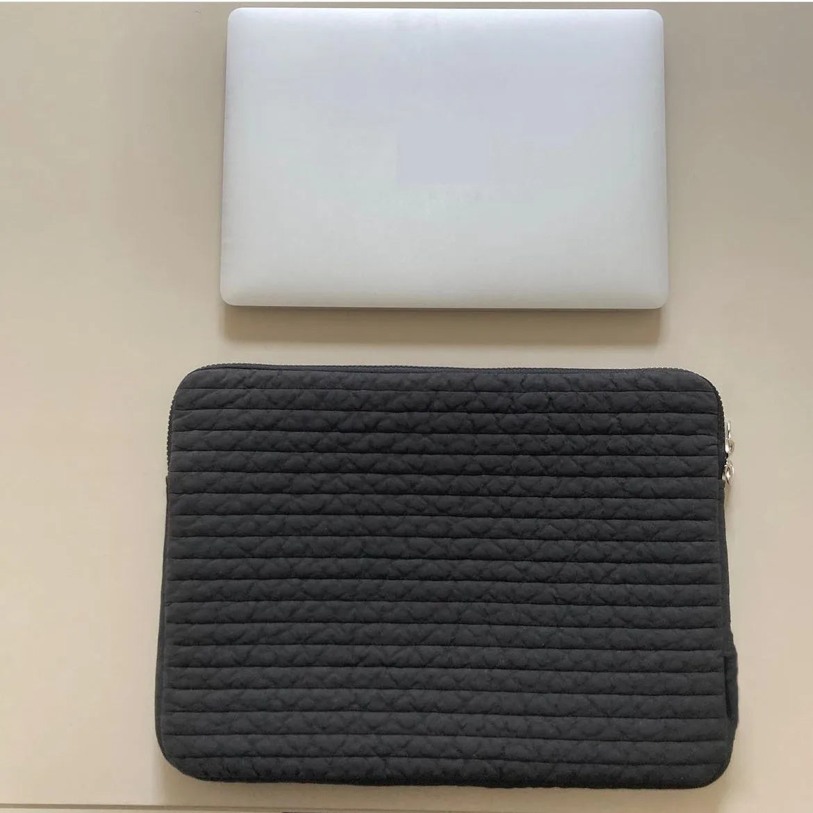 Black and white cotton cloth hand-held clutch bag for anti-seismic tablet protection.