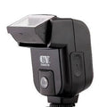 Silver SLR camera flash unit with tilt mechanism mounted on camera hot shoe