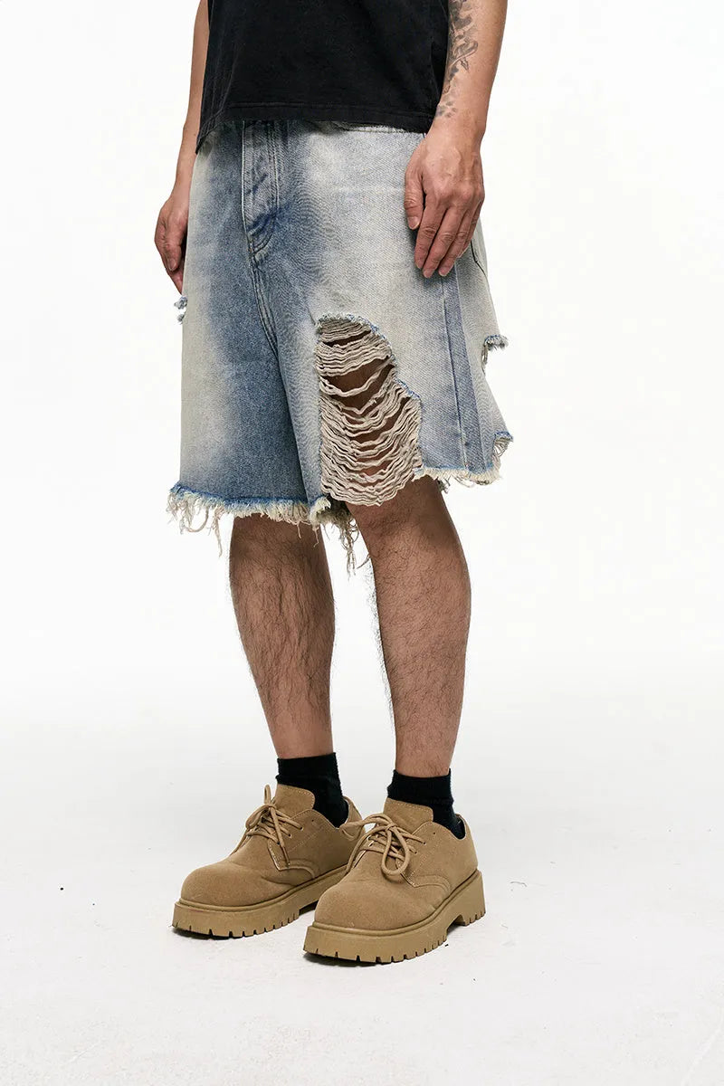 Light blue washed denim shorts with baggy wide leg cut and zipper fly