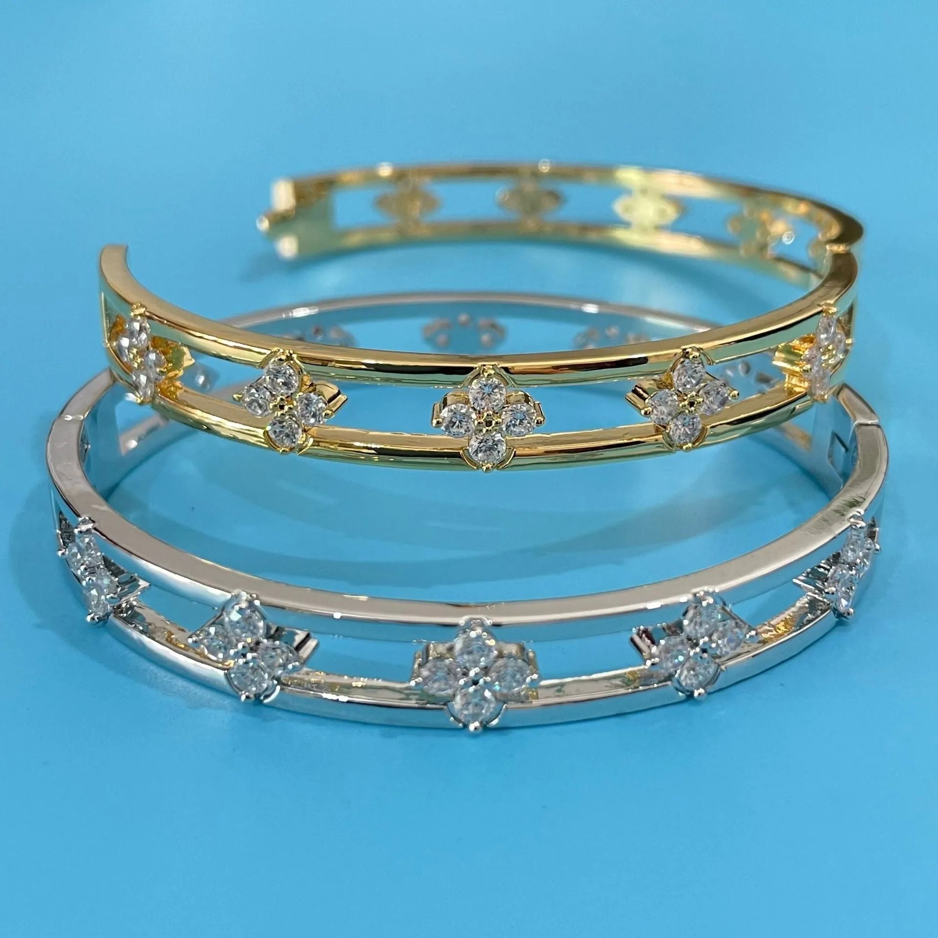 Women's simple hollow bracelet with four-leaf clover charm in gold or silver finish