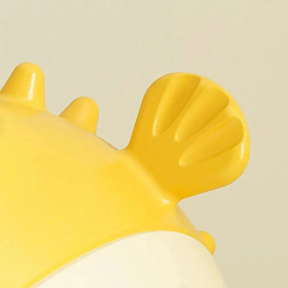Yellow fish-shaped durable vinyl dog chew toy with textured surface and squeaker.
