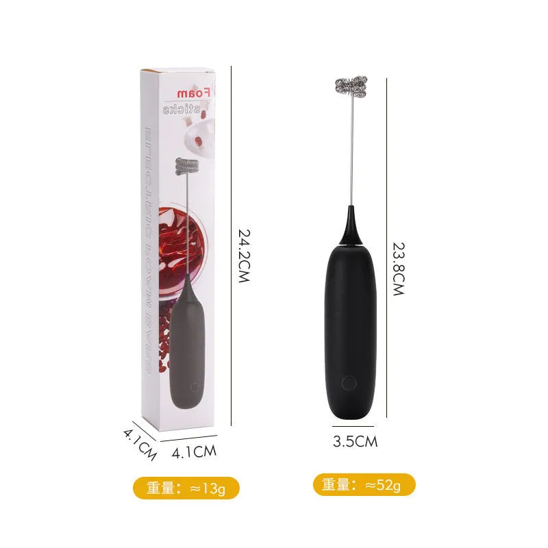 Black and white handheld electric milk frother and blender on a kitchen counter.