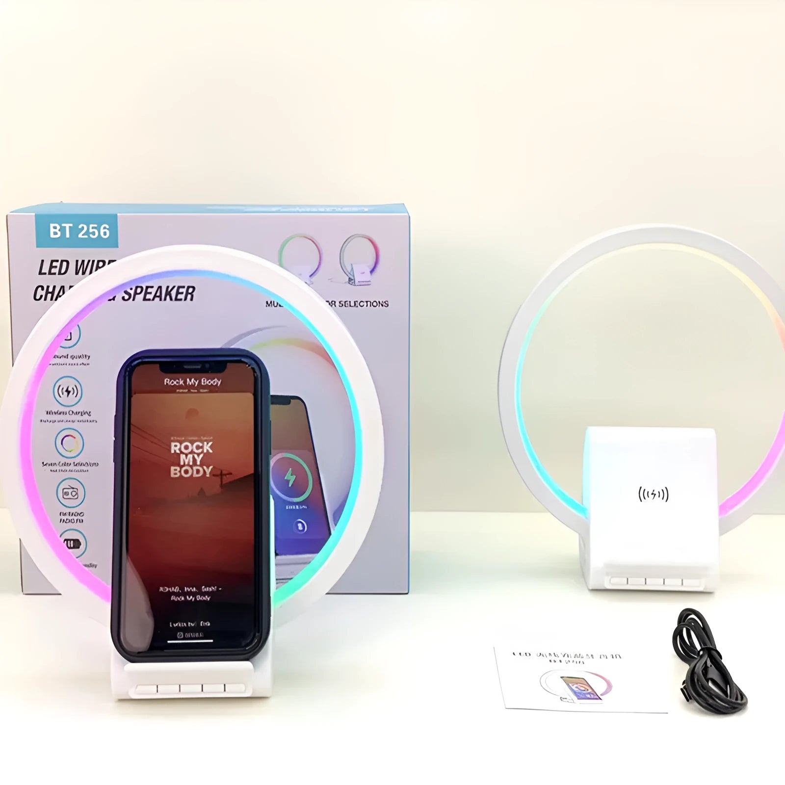 White smart Bluetooth speaker with wireless charging surface and LED ambience lighting