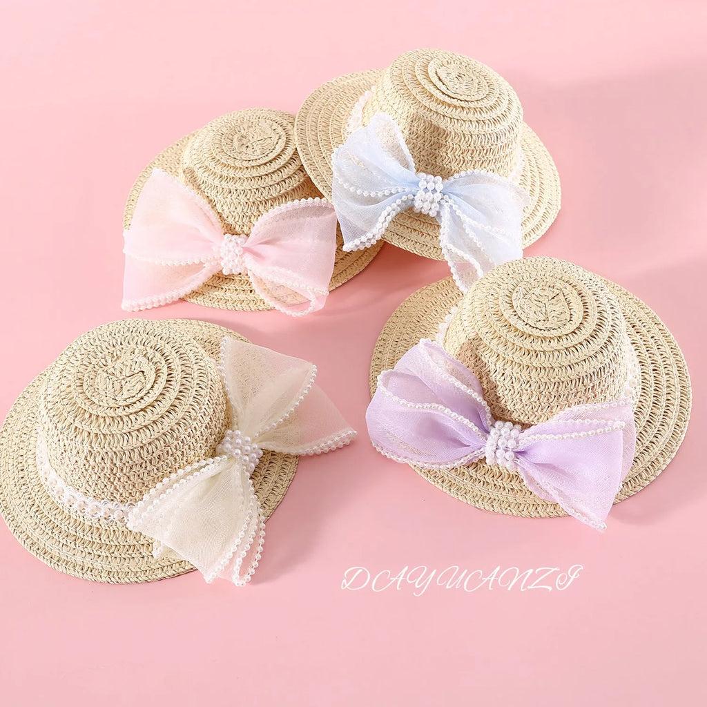 Woven straw pet hat with pearl bow decoration in pink, purple, blue or white colour options