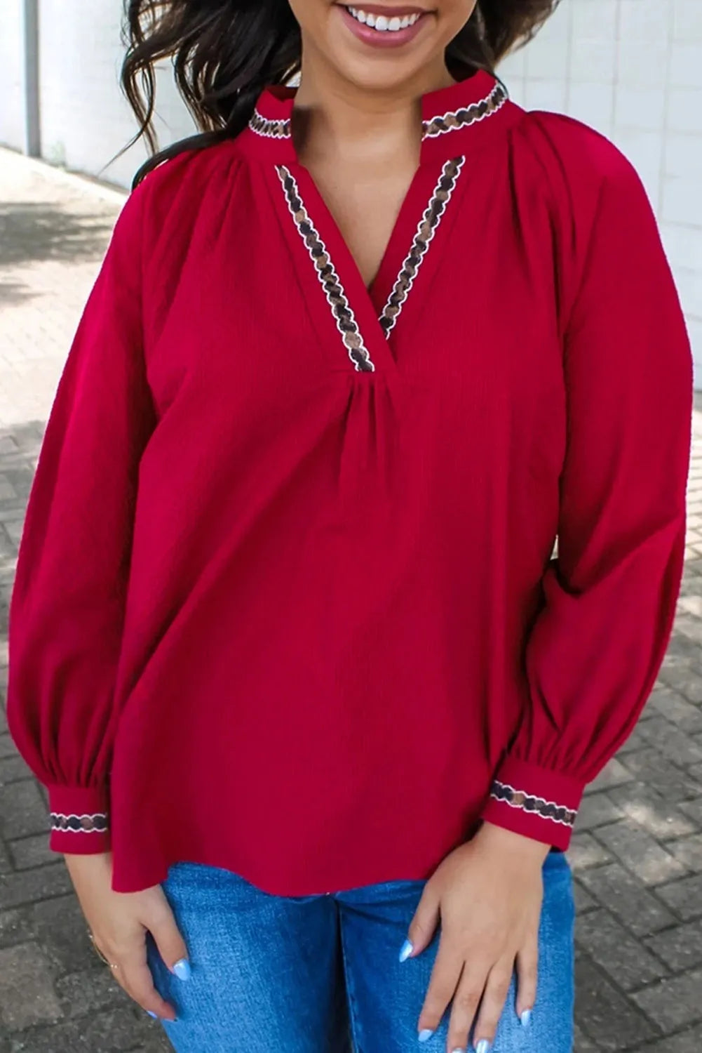 Women's red polyester pullover shirt with embroidered collar and printed design, loose fit