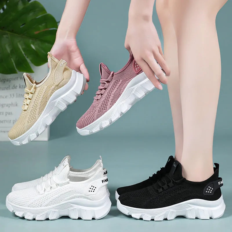 Women's white Flyknit running sneakers with thick PVC sole and lace-up front.