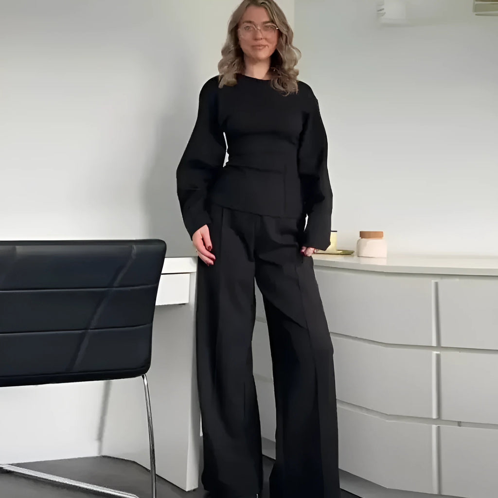 Women's black polyester pleated top and wide leg trousers suit set on a hanger