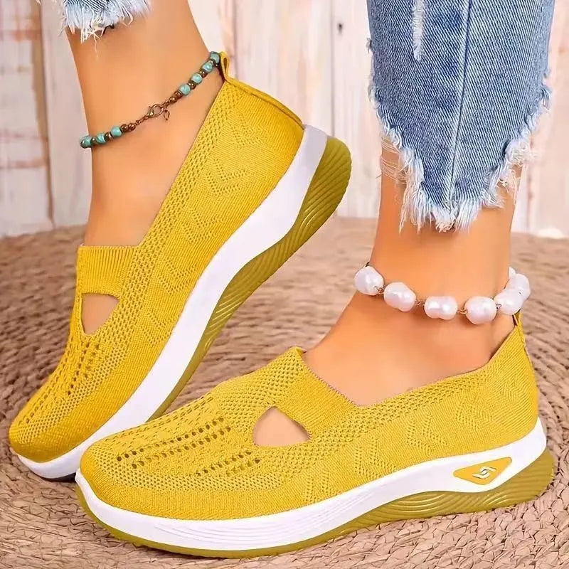 Women's low-top mesh casual flats with a T-strap in various colours on a soft PVC sole.