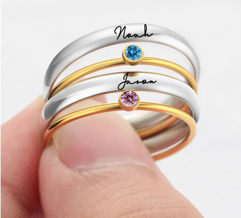Close-up of a geometric titanium steel ring with an engraved December birthstone colour design on the band.