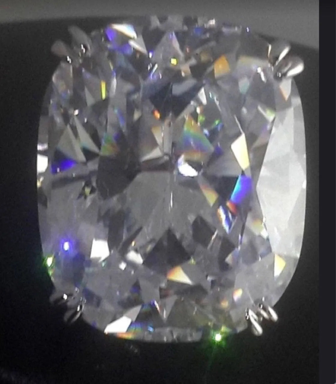 Simple white gold colour alloy ring with an inlaid square diamond, shown on a finger.