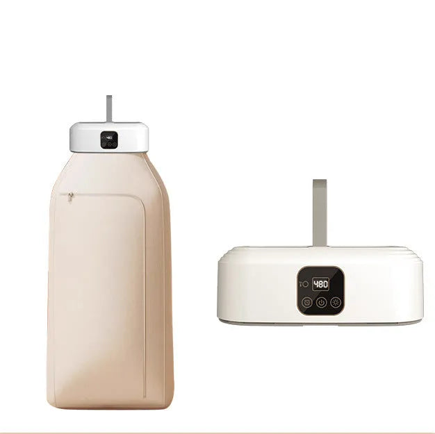 White cylindrical foldable laundry dryer with remote control on a table.