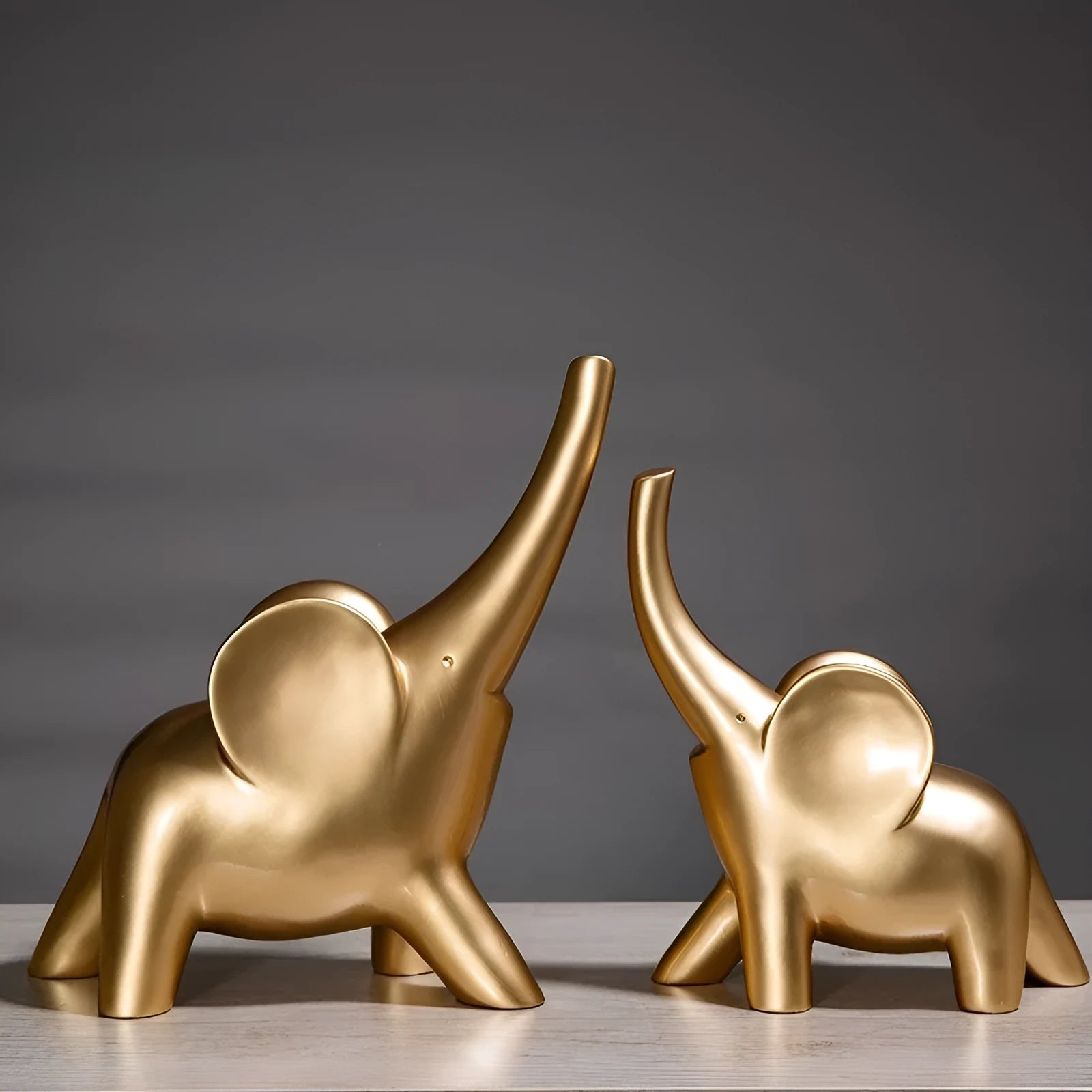 Modern resin and plastic elephant ornament in rose gold or white colour, available in large, small, or pair sizes.