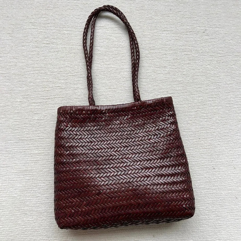 Brown handmade vintage woven leather tote bag with three-dimensional outer pockets.