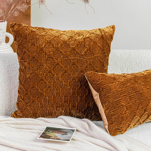 Brown gold antique-style quilted square cushion pillow and matching lumbar pillow on a sofa.