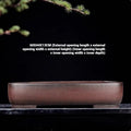 Handmade rectangular purple clay flower pot on a tabletop