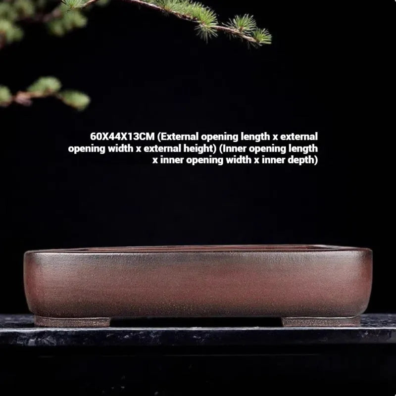 Handmade rectangular purple clay flower pot on a tabletop