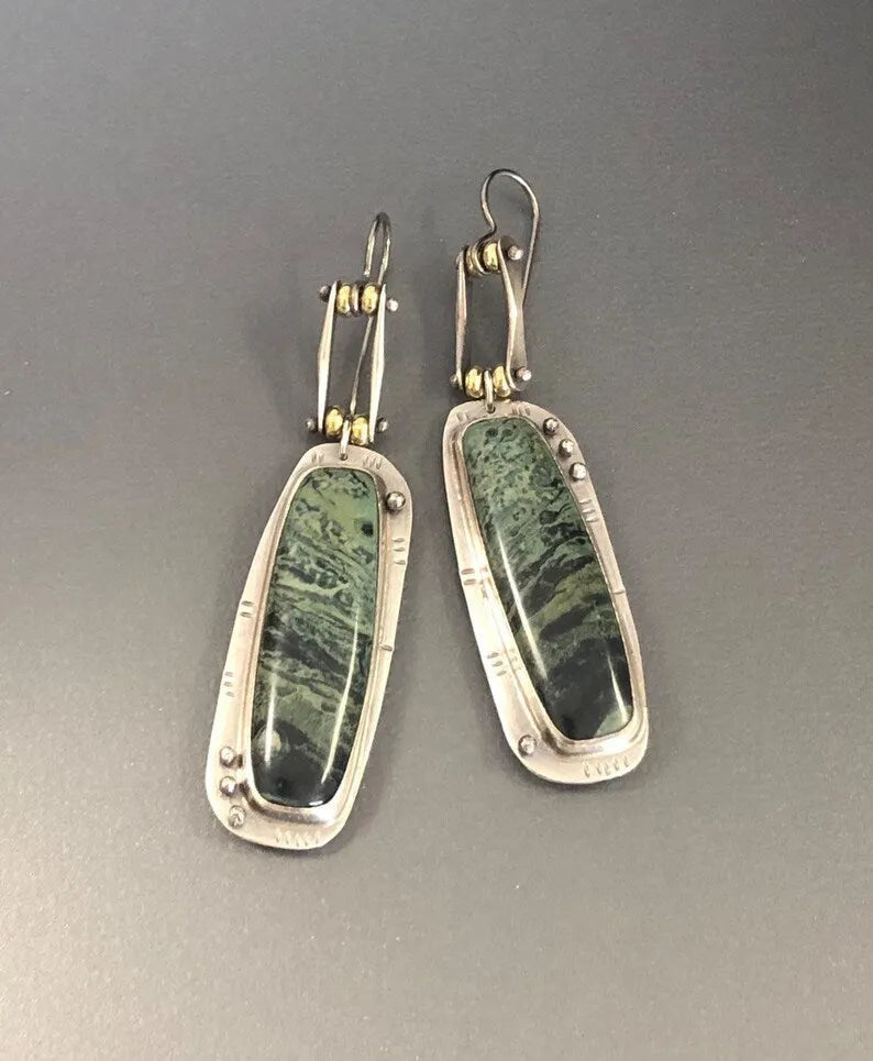 A pair of geometric-shaped fashion earrings with a two-colour marble pattern, made from alloy metal.