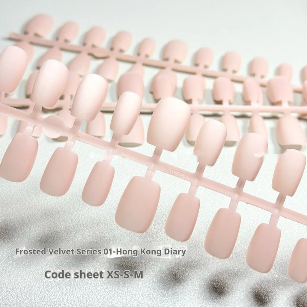 Set of frosted velvet Cat's Eye artificial nail tips in short ladder sizes on a display card.
