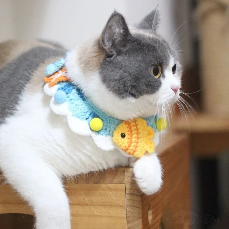 Hand-woven wool cat collar with cartoon Underwater World pattern in blue, size example on a light background