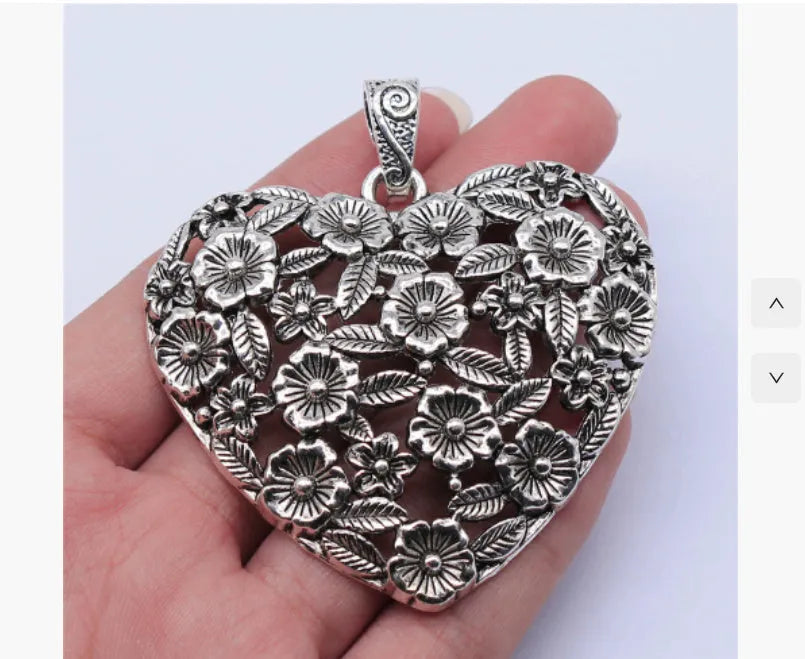 Ancient silver hollow flower love pendant measuring 67mm by 58mm with electroplated finish