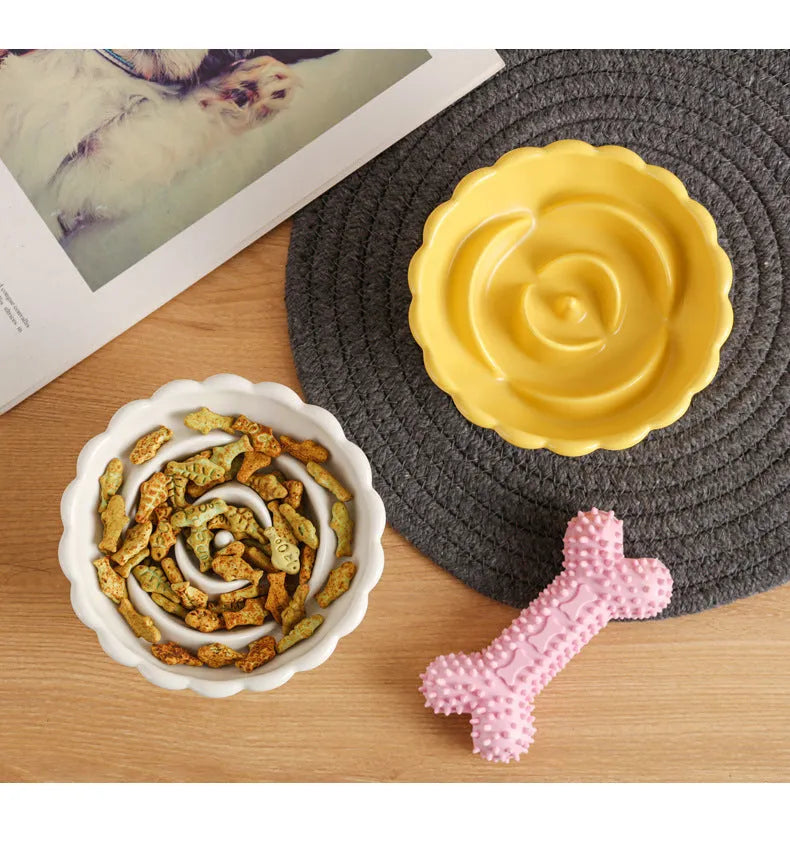 Ceramic slow feed dish with flower pool design and higher edges for cats and small dogs, shown in pink.