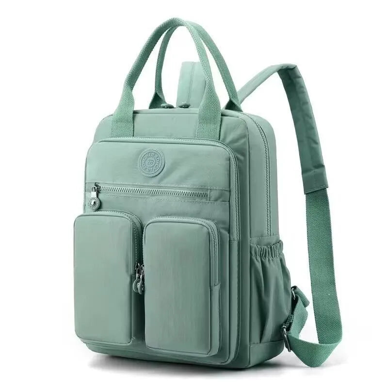 Waterproof nylon travel backpack in lotus root purple colour, showing multiple internal compartments and an external 3D pocket.