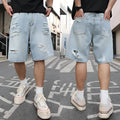 Light blue ripped denim shorts with a distressed wash and loose straight-leg fit on a model.