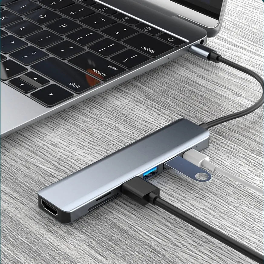 Seven-in-one Type-C USB expander hub with a short 0.145m cable on a white background.