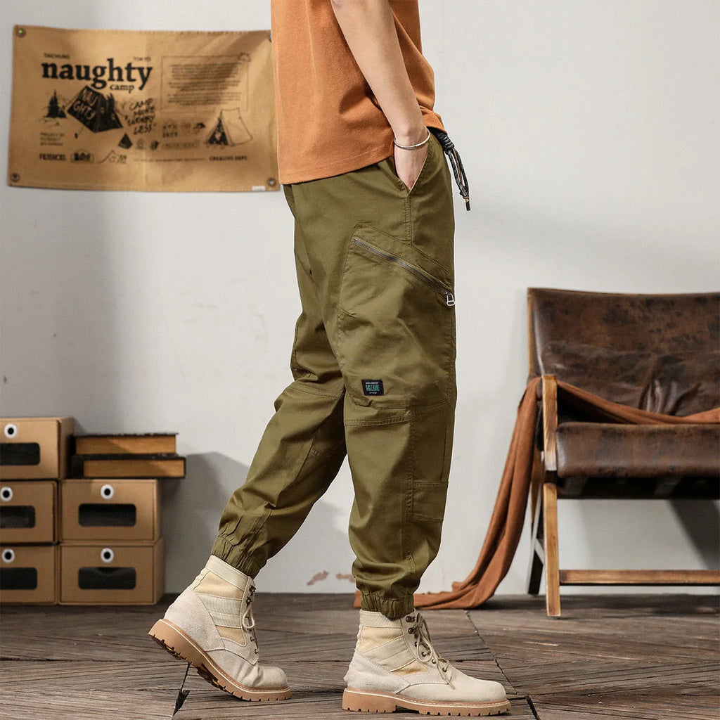 Men's khaki cotton tapered harem pants with a small ankle opening and mid-waist design on a neutral background.
