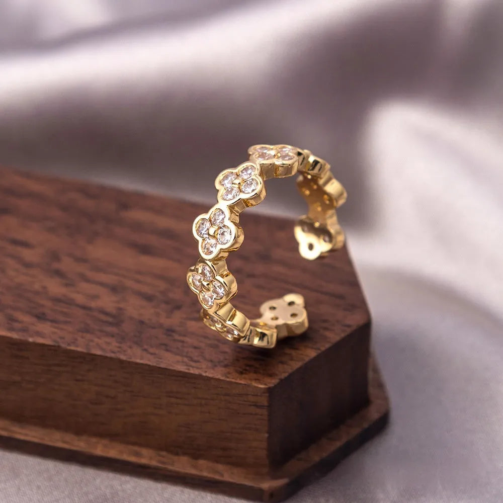 Copper open mouth ring with zircon ornament, adjustable U-shaped design, electroplated J-060 gold finish on grey background
