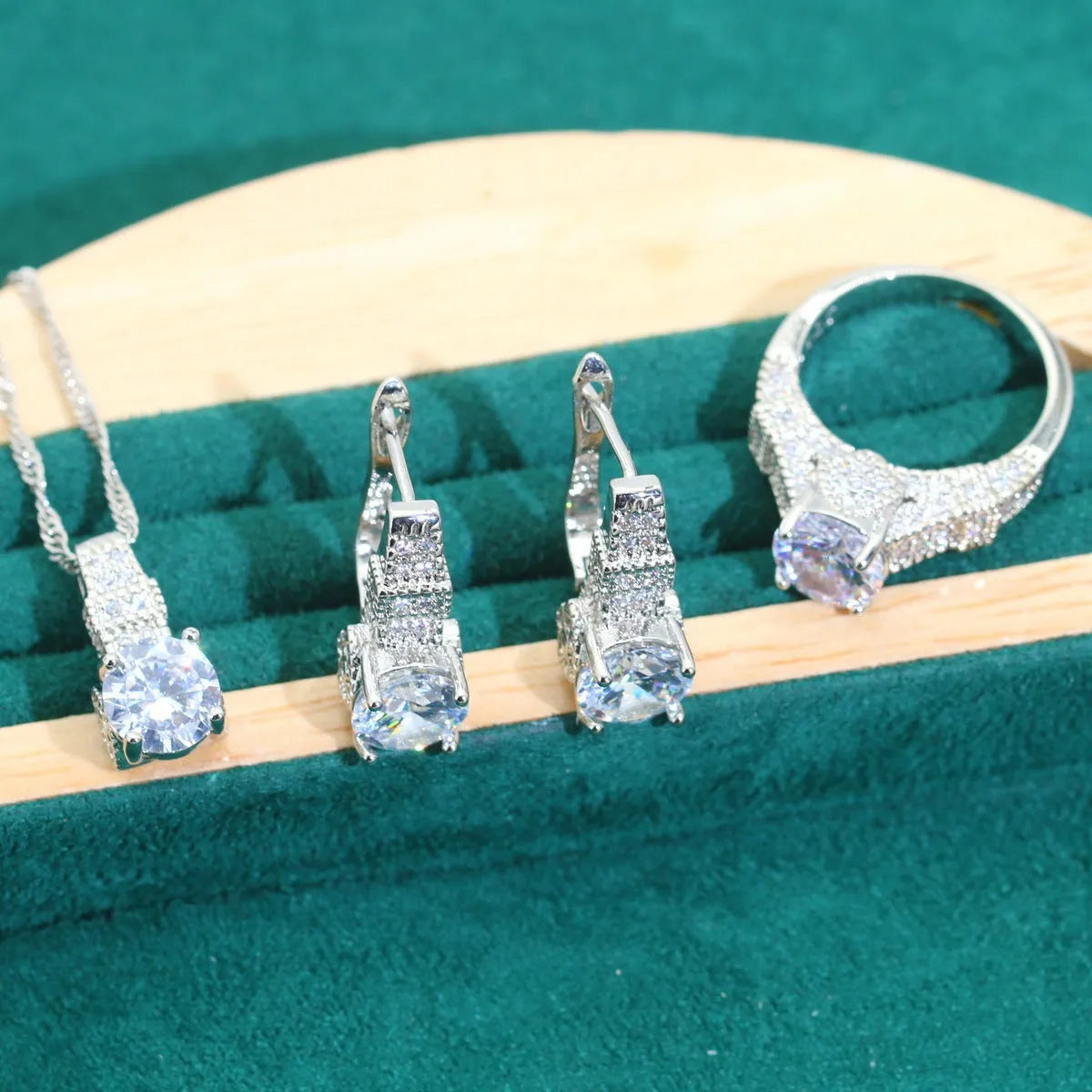 Bridal zircon four-piece jewellery set showing necklace, bracelet, earrings and ring in alloy with water wave chain