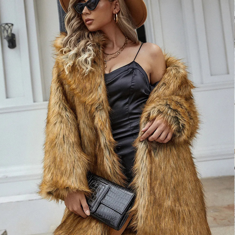 Yellow loose-fitting women's faux fur coat with regular sleeves on a hanger.