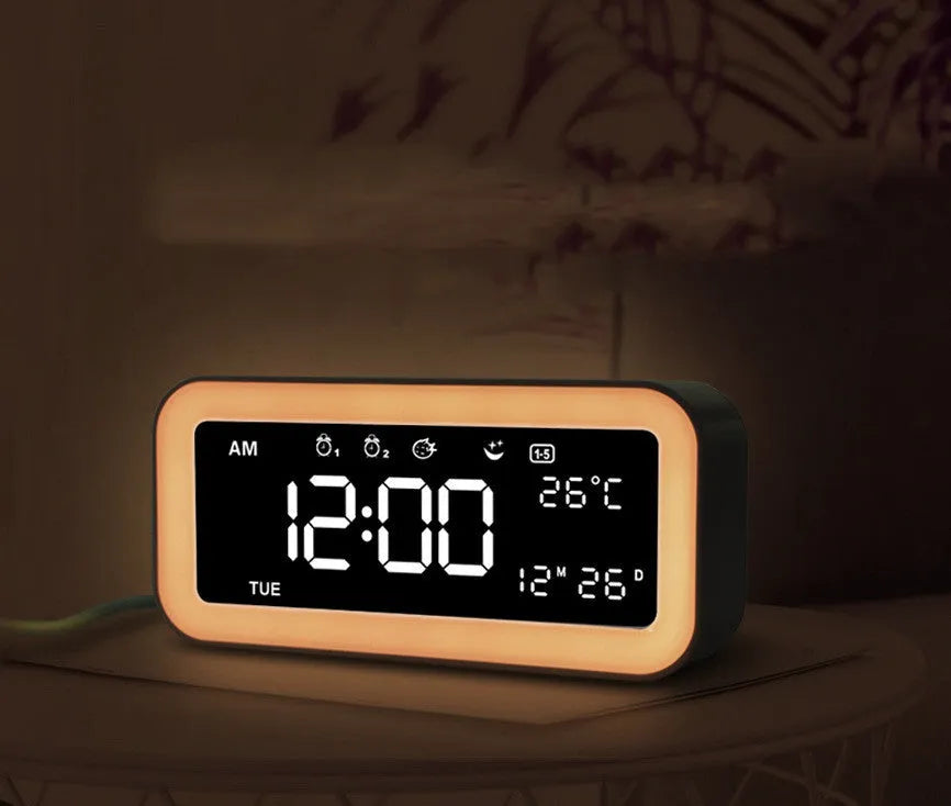 Blue rectangular LED atmosphere light alarm clock with digital display on a table.