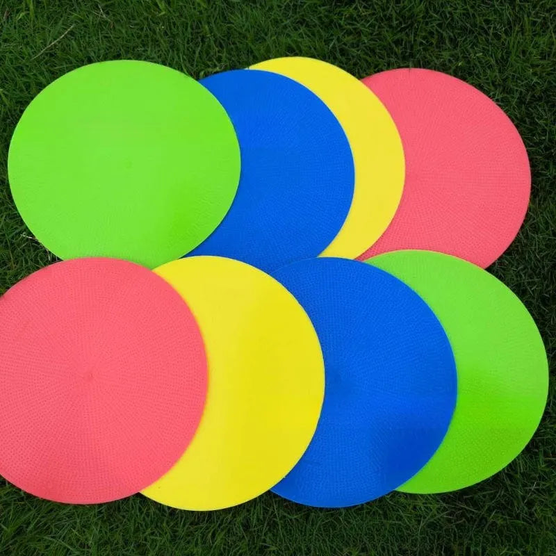 Soft coloured football training marker disc on grass field for target practice