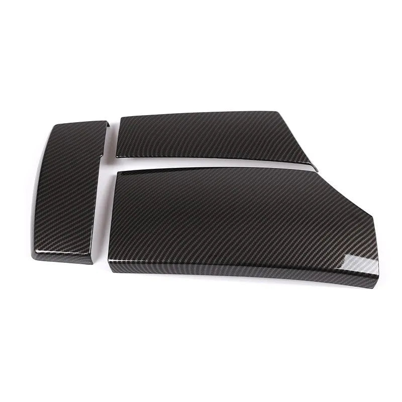Set of three black ABS car armrest box protective covers with a diagonal carbon fibre weave pattern and shiny finish.
