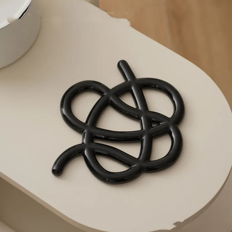 Ceramic heat proof mat with irregular modern shape in bright black, splash ink, or coconut milk grey colour