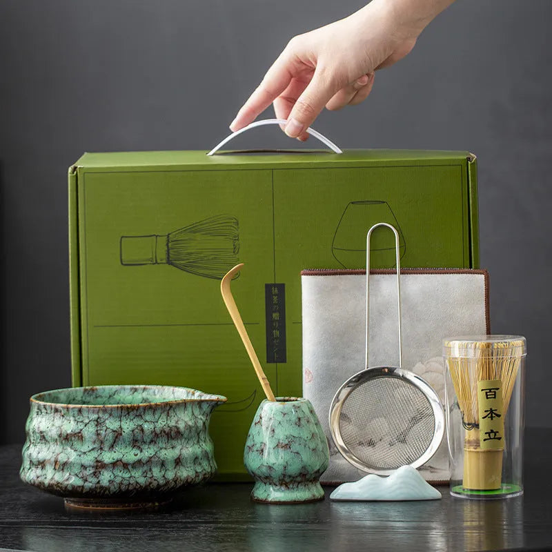 Seven-piece Japanese style matcha set with ceramic bowl, bamboo whisk, stand, tea tray, filter screen, and tea towel in gift box