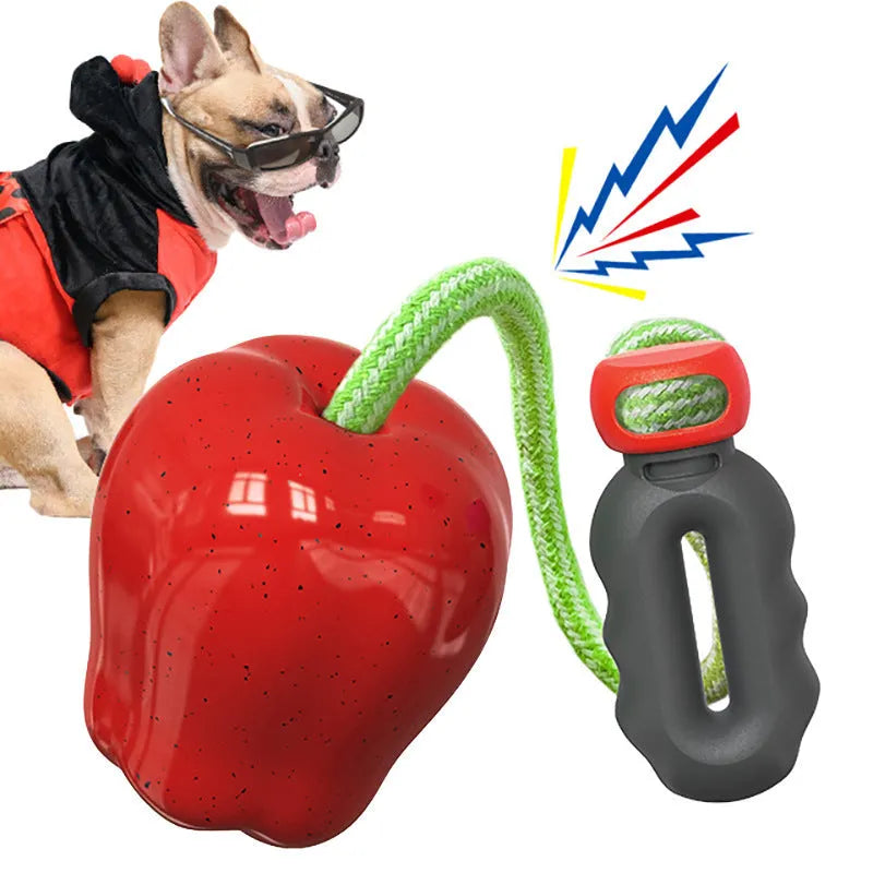 Green apple-shaped dog molar toy with dropping ball mechanism on white background