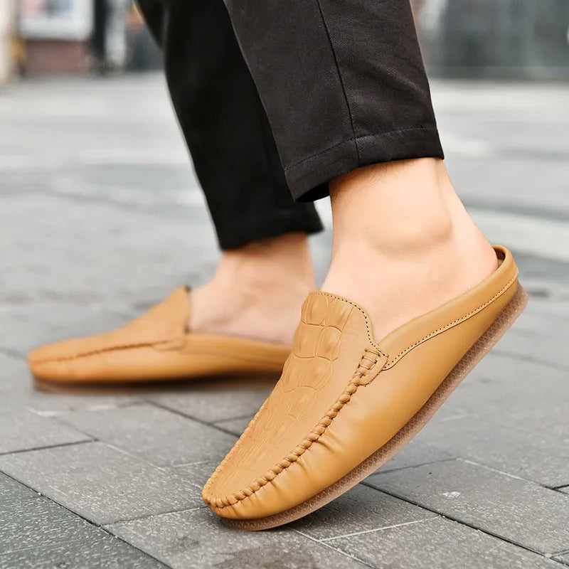 Men's black Gommino-style leisure semi-slippers with artificial PU upper and rubber sole on a white background.