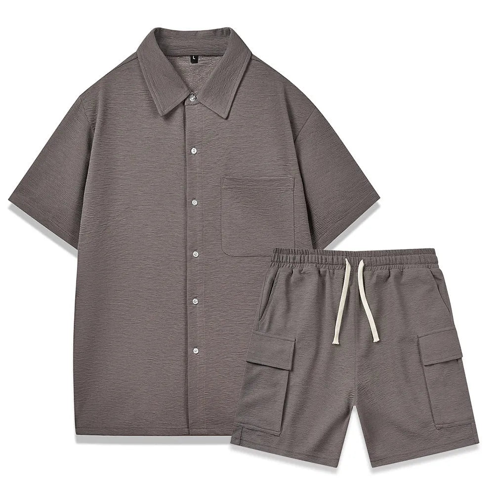 Beige polyester two-piece set with short sleeve top and elastic waist shorts laid flat.