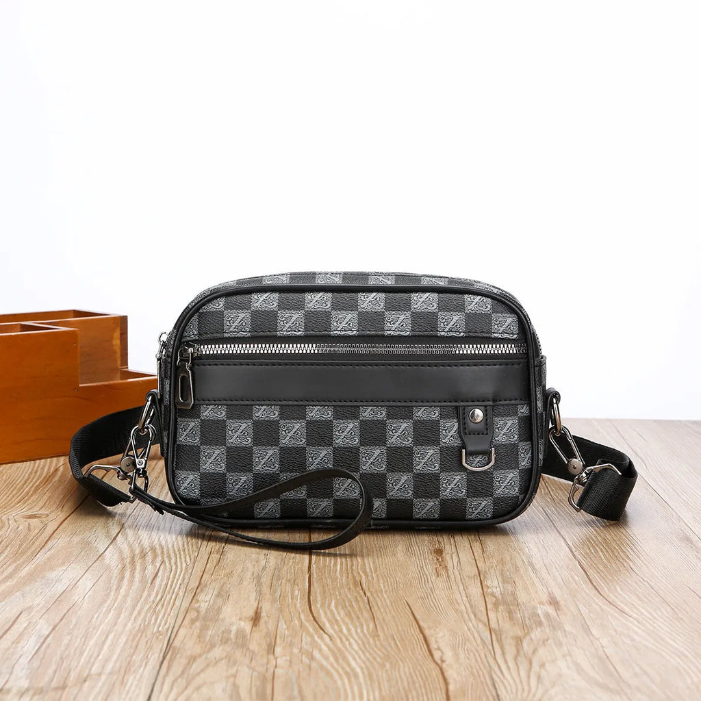 Men's black PU leather messenger bag with a geometric pattern, shown worn crossbody.