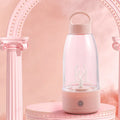 Automatic electric shaker bottle with USB port, handle, and blending blade in green, pink, or white.