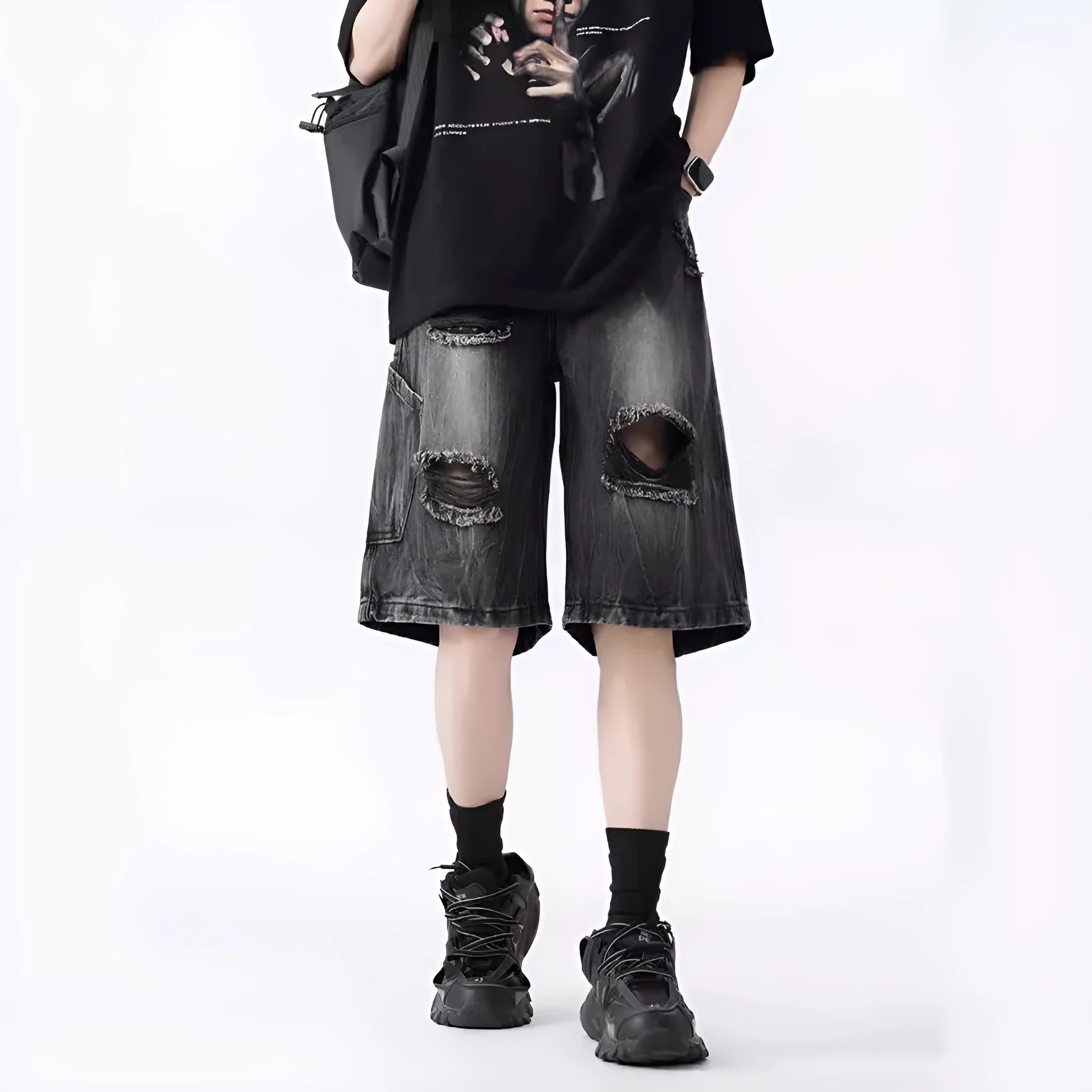 Men's loose fit distressed denim shorts in black vintage style with ripped detailing