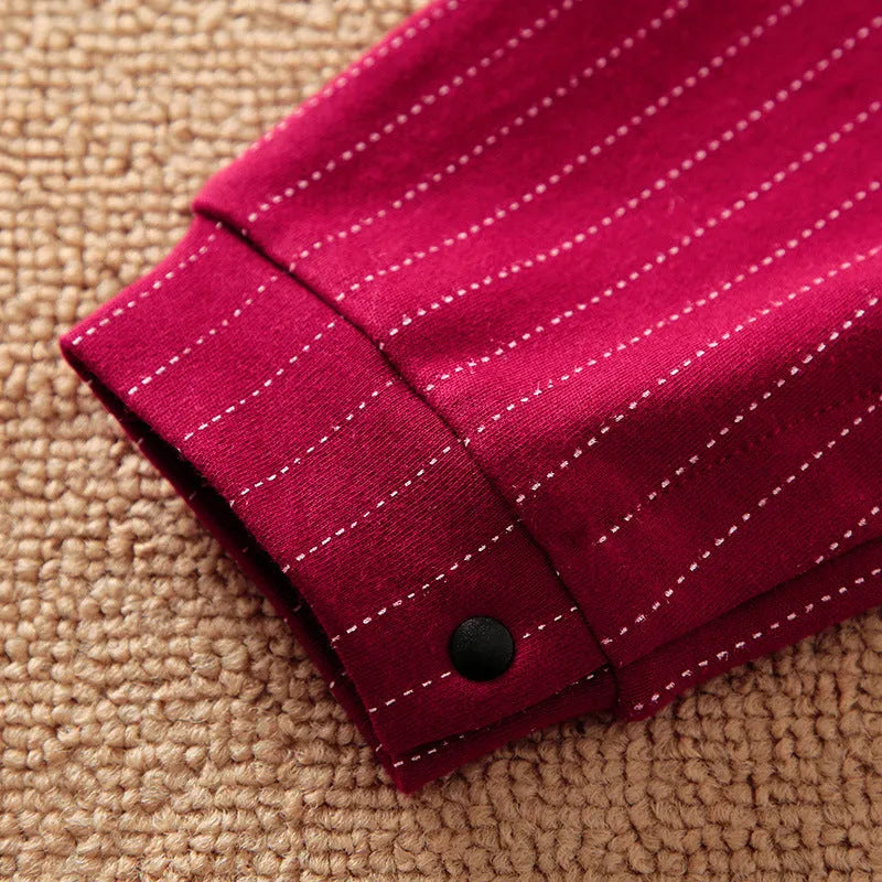 Wine red cotton baby boy romper with long sleeves and a single-breasted front, laying flat.